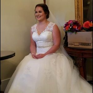 A beautiful wedding dress. Illusion back. A line. Elegant. Buttons up the back.